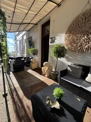 a patio with a table with a cat sitting on it at Spirit of Queen experience in Barcelona