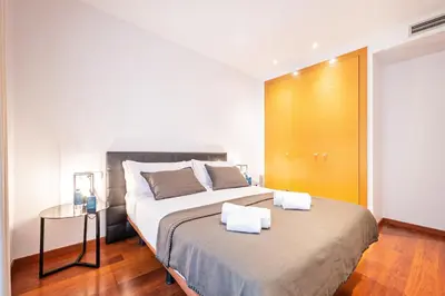a bedroom with a large bed with two towels on it at Sweett - Eixample Central in Barcelona