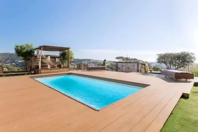 a bedroom with a bed and a mirror on the wall at \u30c4 Villa Carrasca l Luxe l Vista al Mar l Piscina Climatizada l Nature in Arenys de Munt