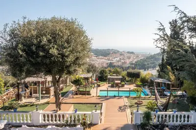 a view of a swimming pool with a playground at \u30c4 Villa Carrasca l Luxe l Vista al Mar l Piscina Climatizada l Nature in Arenys de Munt
