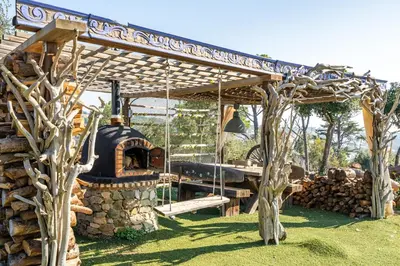 a bed frame made out of tree branches at \u30c4 Villa Carrasca l Luxe l Vista al Mar l Piscina Climatizada l Nature in Arenys de Munt