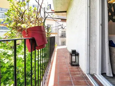 a plant in a hanging basket on a balcony at Pura Vida Apartment by Hello Homes Sitges in Sitges