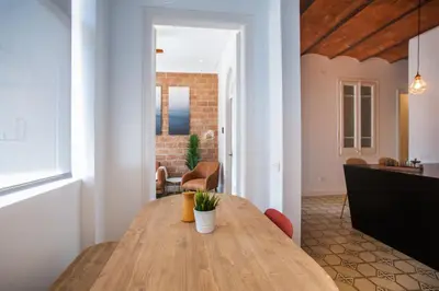 a dining room with a wooden table in a room at Tendency Apartments Miro 8 in Barcelona