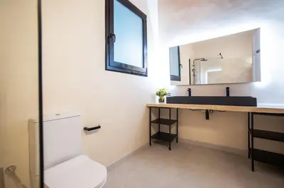 a bathroom with a sink and a mirror at Tendency Apartments Miro 8 in Barcelona
