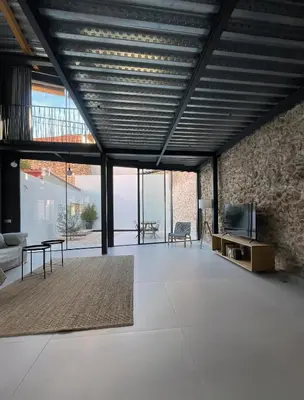 a large living room with a couch and a tv at villa en el penedès in Gornal
