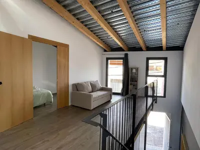 a living room with a couch and a mirror at villa en el penedès in Gornal