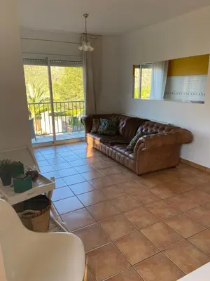 a living room with a couch and a tile floor at RACÓ DEL GARRAF Ca la Matilde house BBQ and POOL in Olivella