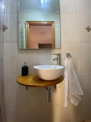 a bathroom with a white sink and a mirror at RACÓ DEL GARRAF Ca la Matilde house BBQ and POOL in Olivella