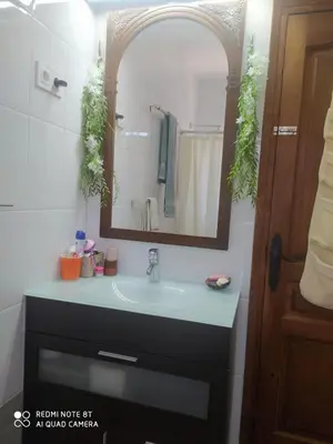 a bathroom with a sink and a mirror at Habitación privada en casa particular, montaña in Olesa de Bonesvalls
