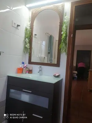 a bathroom with a sink and a mirror at Habitación privada en casa particular, montaña in Olesa de Bonesvalls