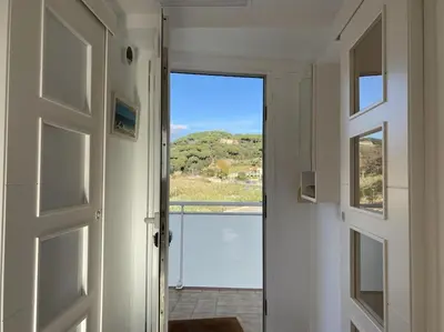 a door leading to a room with a view at Montaber Apartments - Sant Pol de Mar in San Pol de Mar