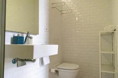 a white bathroom with a sink and a toilet at 