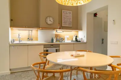 a kitchen with a table and chairs and a clock at 