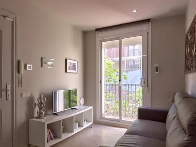 a living room with a couch and a television at Stay U-nique Apartments Torre Damians in Barcelona