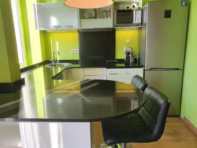 a kitchen with a black table and chairs in it at Apartamento Llibertat centro in Vilanova i la Geltrú