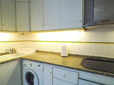 a kitchen with a washing machine on a counter at Sunflower Apartment by Hello Homes Sitges in Sitges