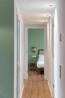 a hallway with a bedroom with a bed in it at Caliu Apartments Barcelona - Camp Nou in Hospitalet de Llobregat