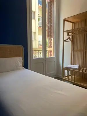 a bedroom with a white bed and a window at Caliu Apartments Barcelona - Camp Nou in Hospitalet de Llobregat