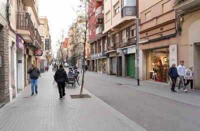 a group of people walking down a city street at Caliu Apartments Barcelona - Camp Nou in Hospitalet de Llobregat