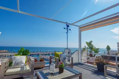 a balcony with chairs and a view of the ocean at The Moonlight Sea View by Hello Homes Sitges in Sitges