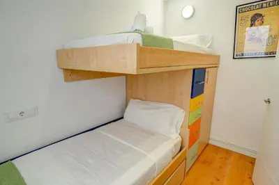 a small bunk bed in a small room at The Moonlight Sea View by Hello Homes Sitges in Sitges
