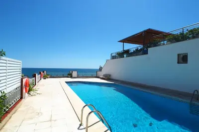 a swimming pool on the side of a building at The Moonlight Sea View by Hello Homes Sitges in Sitges