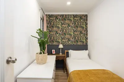 two beds in a room with a wallpaper at Vintage 3 Bdr Apartment in Esplugues de Llobregat