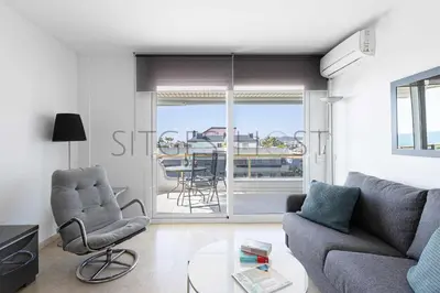 a living room with a couch and chairs and a table at Sitges ARENA - dos piscinas frente al mar in Sitges