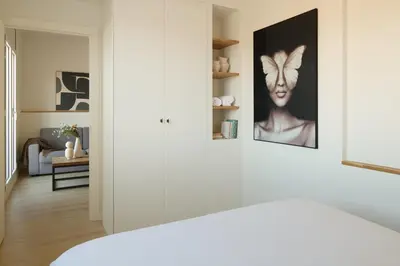 a white room with a picture of a woman on the wall at Factory Apartments Barcelona in Barcelona