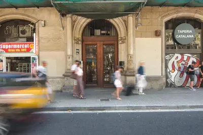 a group of people walking in front of a building at Factory Apartments Barcelona in Barcelona