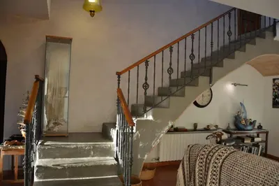 a staircase in a living room with a stair case at Villa Sitges Julia Vista Espectacular 2 k m s de la Playa Comoda & Area Tranquila Amplitud interior y plana in Sitges