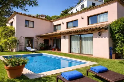 a house with a swimming pool in the yard at Villa Sitges Julia Vista Espectacular 2 k m s de la Playa Comoda & Area Tranquila Amplitud interior y plana in Sitges