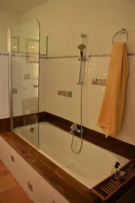 a bathroom with a bath tub with a glass shower at Villa Sitges Julia Vista Espectacular 2 k m s de la Playa Comoda & Area Tranquila Amplitud interior y plana in Sitges