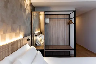 a bedroom with a shower with a bed and a mirror at Petit Palace Eixample in Barcelona