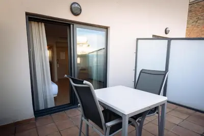 a white table and chairs in a room at Petit Palace Eixample in Barcelona