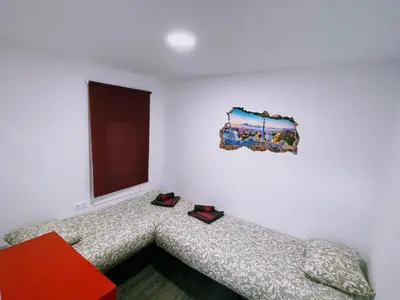 a bedroom with a bed with shoes on it at Magnifico Apartamento Barca 4 in Sant Adria de Besos