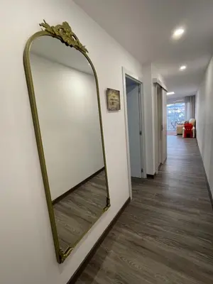 a large mirror on a wall in a hallway at Magnifico Apartamento Barca 4 in Sant Adria de Besos