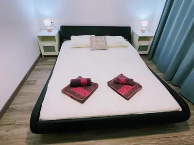 a bed with two pillows on it in a room at Magnifico Apartamento Barca 4 in Sant Adria de Besos