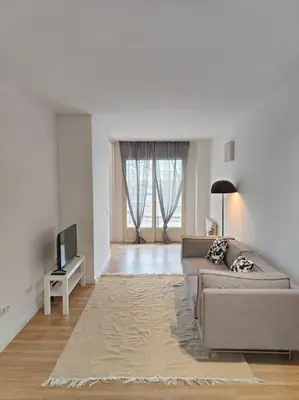 a living room with a couch and a tv at Cute apartment Sant Adria beach in Sant Adria de Besos