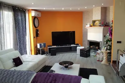 a living room with a couch and a christmas tree at Casa con vistas al mar in Castelldefels