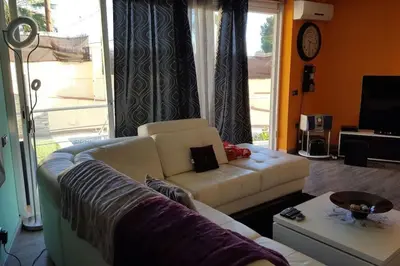 a living room with a couch and a table at Casa con vistas al mar in Castelldefels