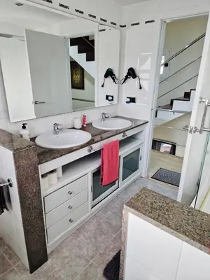 a bathroom with two sinks and a large mirror at Casa con vistas al mar in Castelldefels