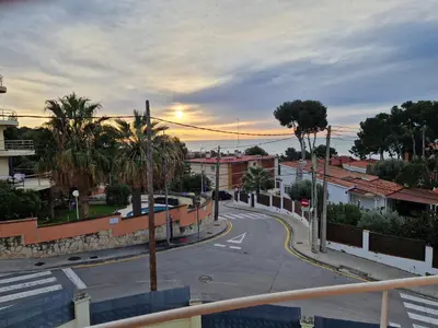 a view of a city street with palm trees at Casa con vistas al mar in Castelldefels