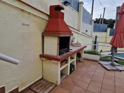 an outdoor brick oven sitting on a patio at Casa con vistas al mar in Castelldefels