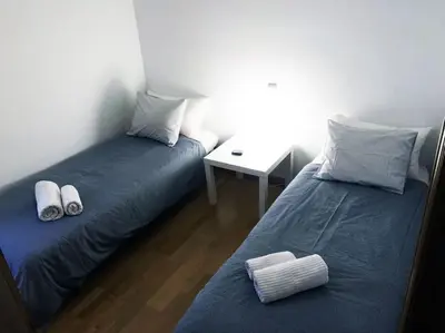two beds sitting next to each other in a room at MODERNO APARTAMENTO EN EL CENTRO in Vilanova i la Geltrú