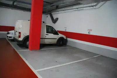 a white van parked in a parking garage at Apartaments Independencia in Barcelona