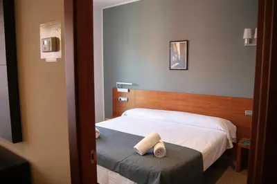 a bedroom with a bed with two towels on it at Apartaments Independencia in Barcelona
