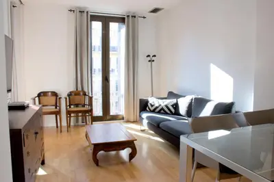 a living room with a couch and a table at SWEET BCN Rambla 48 in Barcelona