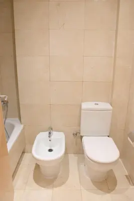 a bathroom with a white toilet and a sink at SWEET BCN Rambla 48 in Barcelona