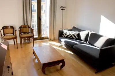 a living room with a couch and a coffee table at SWEET BCN Rambla 48 in Barcelona